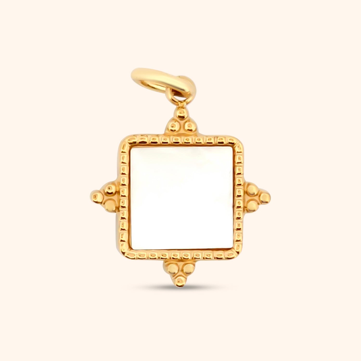Close-up of the Zen Garden Charm, a square gold charm featuring a mother-of-pearl inlay and triangle details at the corners.